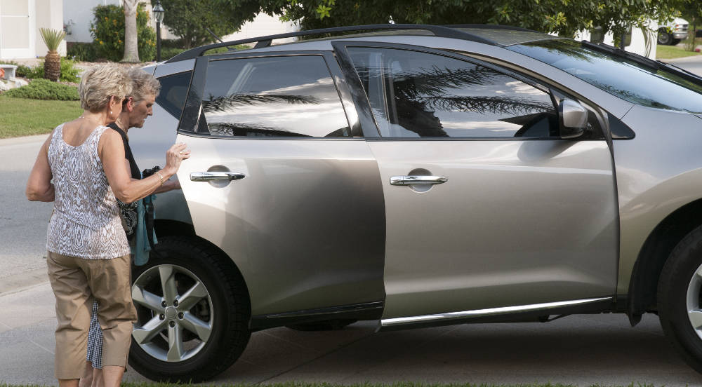 Assisted Rides: Elderly woman receiving ride by a volunteer