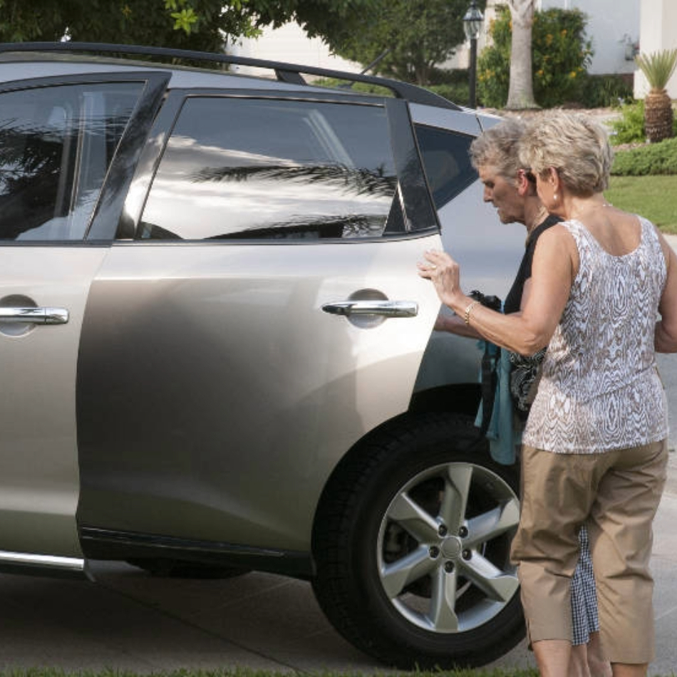 Helping Elderly Woman into a car